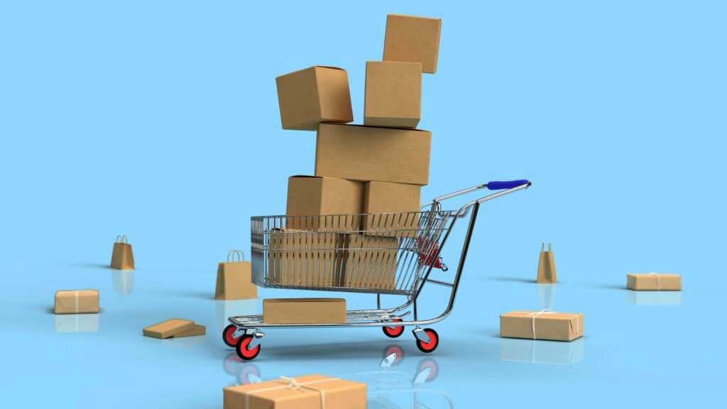 HD 3D render representing the concept of ecommerce. Mini shopping cart holds brown boxes, surrounding by other brown boxes against a light blue background. By Shutter Speed (@shutter_speed_) from Unsplash.