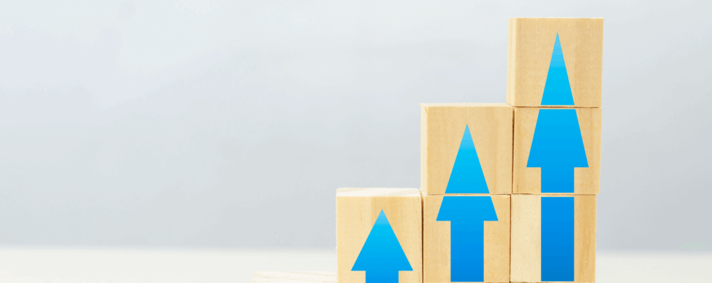 Blocks showing upward arrows, representing the concept of business growth due to partnering with the right digital marketing agency.