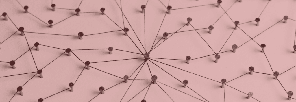 An interconnected web of string to symbolize the concept of interlinking on the internet. Image has a red tint.